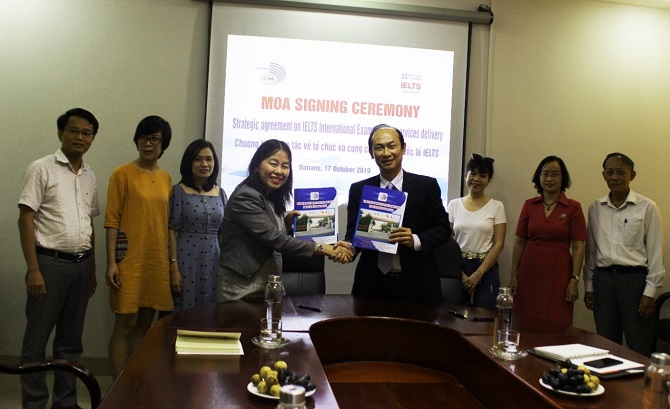 A group of people standing around a tableDescription automatically generated