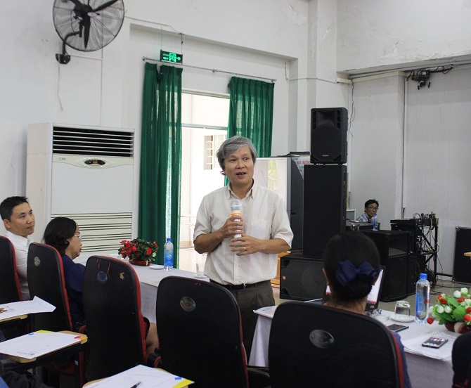 A group of people standing in a roomDescription automatically generated