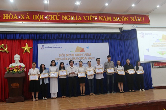 A group of people standing in a roomDescription automatically generated