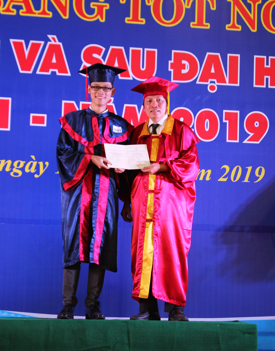 A person holding a sign posing for the cameraDescription automatically generated