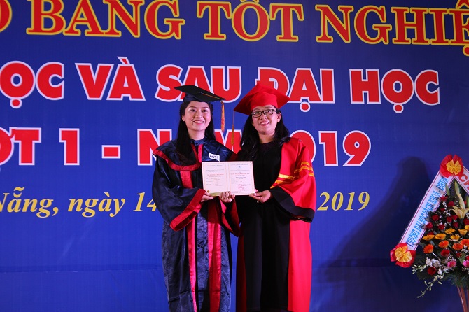 A person holding a signDescription automatically generated