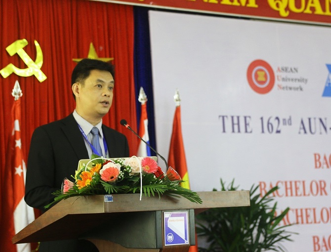 A person sitting at a table using a computerDescription automatically generated