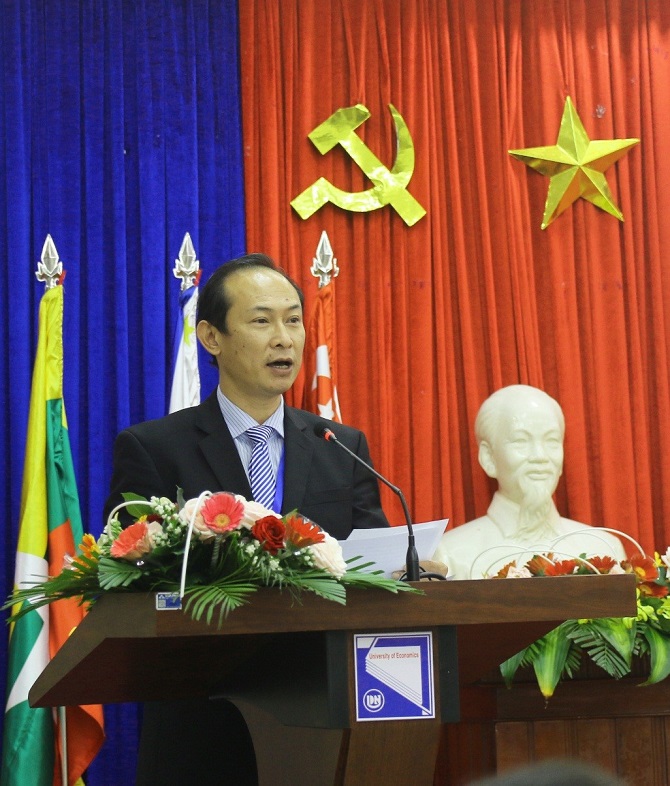 A group of people sitting at a table in front of a curtainDescription automatically generated