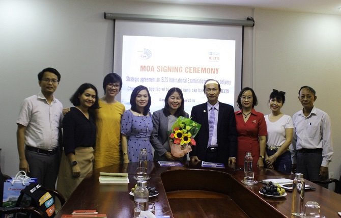 A group of people standing around a table posing for the cameraDescription automatically generated