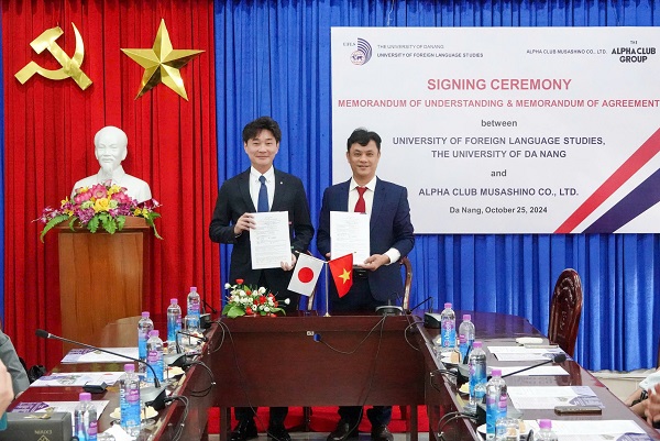 A couple of men holding papersDescription automatically generated