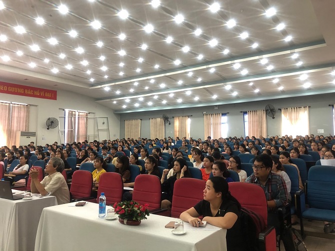 A large crowd of people in a roomDescription automatically generated