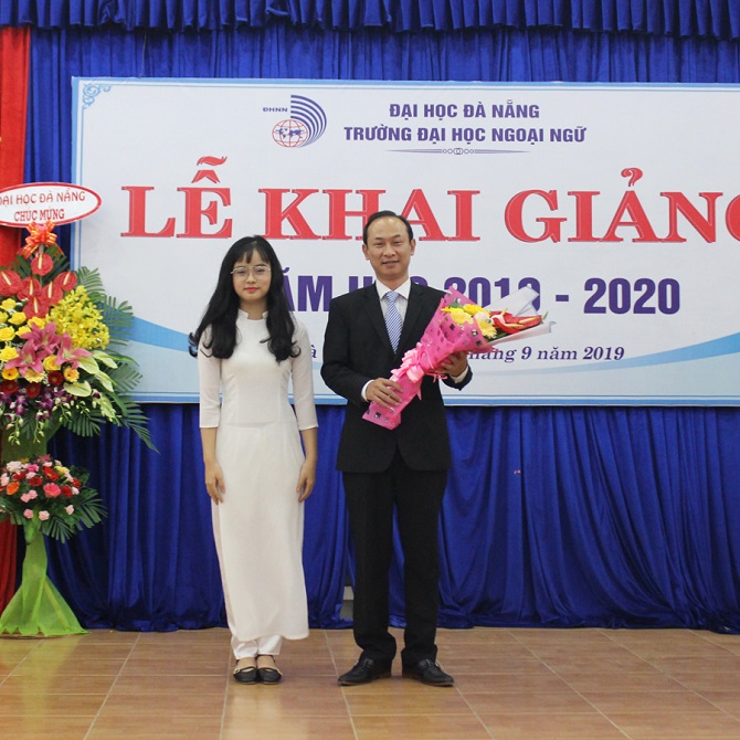 A group of people standing in front of a signDescription automatically generated