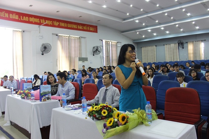 A group of people standing in a roomDescription automatically generated