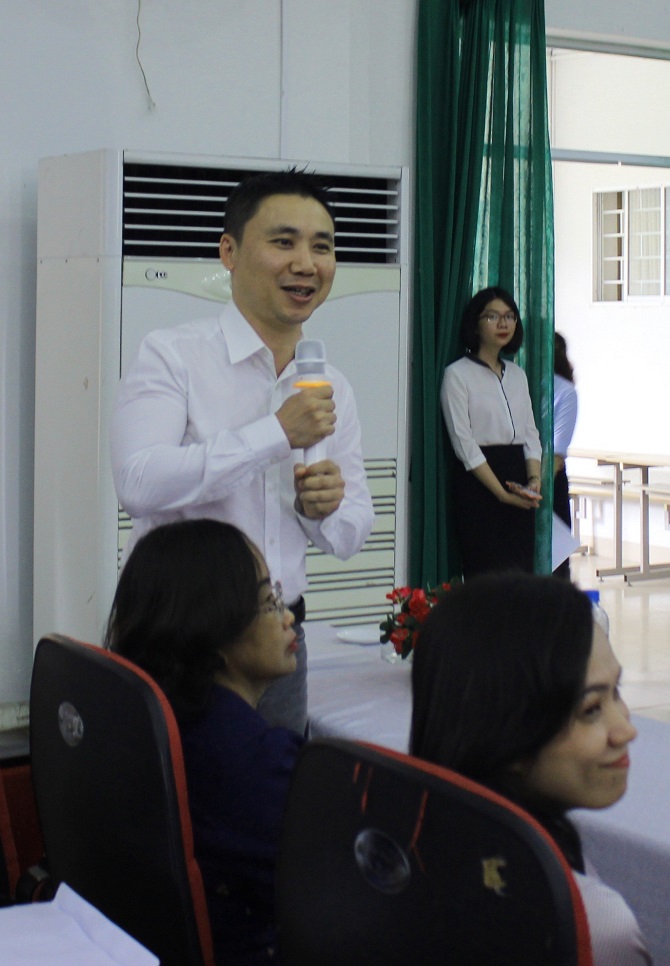 A group of people standing in front of a windowDescription automatically generated