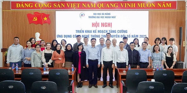 A group of people standing in front of a large screenDescription automatically generated